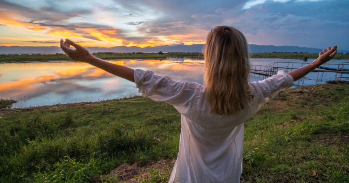 Girl enjoying freedom at sunset, Inle lake